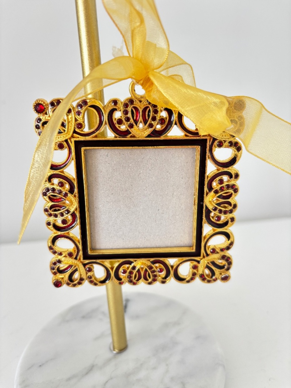 Miniature picture frame gold tone metal with red coloured stones ribbon hanger